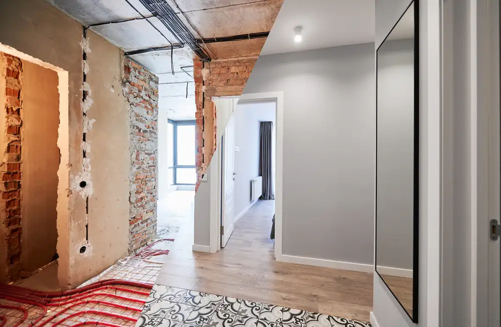 Hallway shown half during works and half after renovation